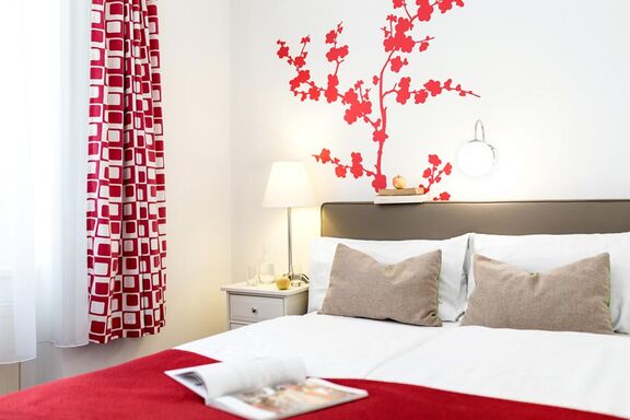 Double bed with wall decorations